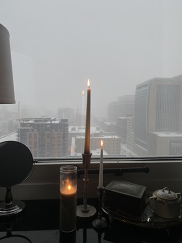 candles burning by a foggy window
